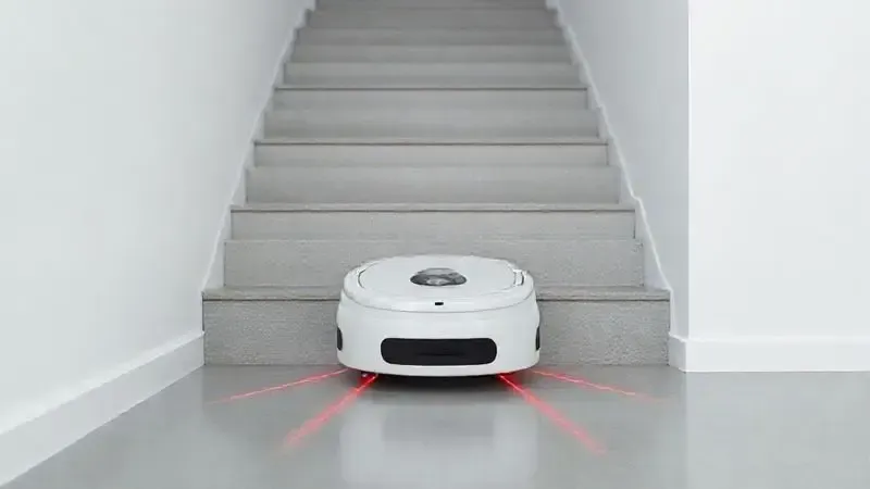 Ilustração 3D de um aspirador robô usando seu sensor antiqueda para evitar cair de uma escada, demonstrando a tecnologia de segurança do aparelho.