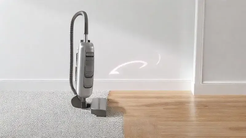 Ilustração conceitual destacando a mobilidade e versatilidade de um aspirador vertical, transitando facilmente entre carpete e piso frio.